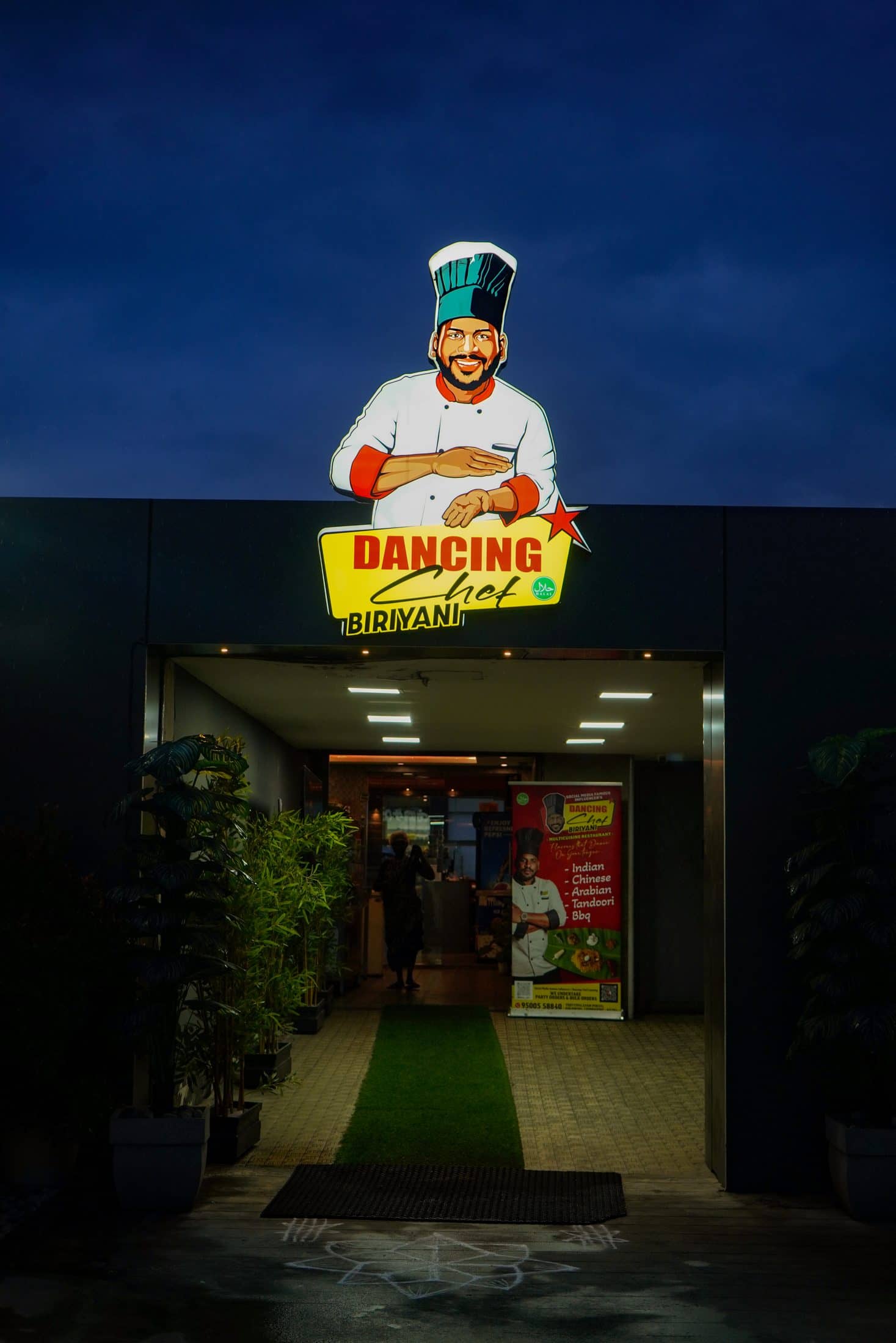 The lit Dancing Chef Biriyani frontage on Avinashi Road after dark